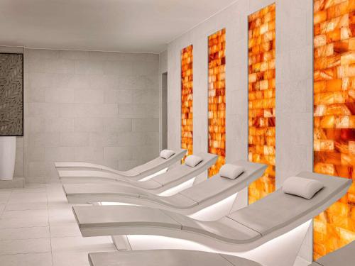 a waiting room with a row of white chairs at Fairmont Windsor Park in Windsor