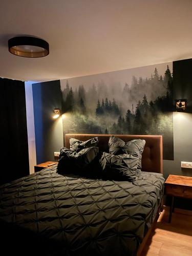 a bedroom with a bed with a painting on the wall at Demhouse in Gössenheim