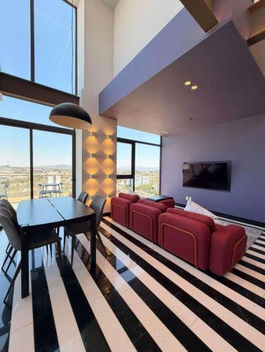a living room with a red couch and a table at Adamant Grand in Laurel de Lagunillas
