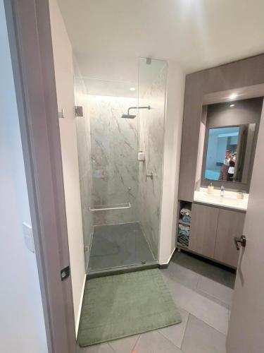 a bathroom with a shower with a glass door at Adamant Grand in Laurel de Lagunillas