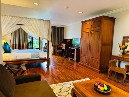 a bedroom with a bed and a living room at Cyberview Resort & Spa in Cyberjaya