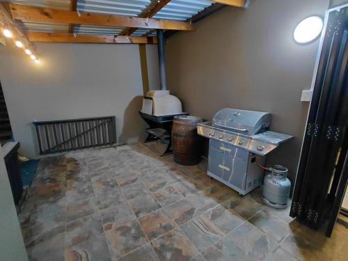 a room with a kitchen with a table and a stove at Underwood Country Manor in Underberg
