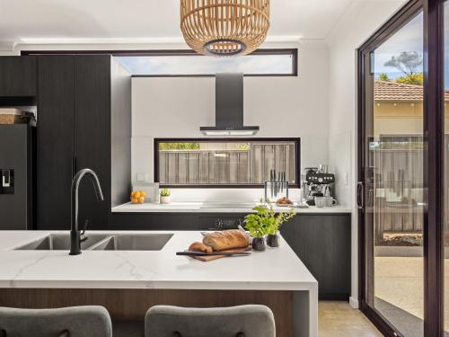 a kitchen with a sink and a counter at Stone River Villa 2 - Private Escape - Heated Pool in Margaret River Town