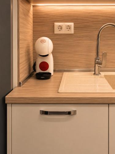 a hello kitty appliance sitting on a kitchen counter at Pool View Apartment Varna in Varna City