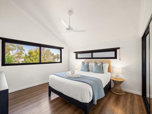 a white bedroom with a bed and a window at Stone River Villa 2 - Private Escape - Heated Pool in Margaret River Town