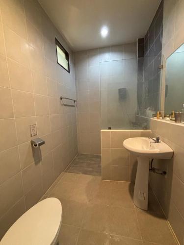 a bathroom with a toilet and a sink and a shower at Clock Tower Apartments Chroma Pulse in Pai