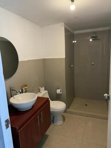 a bathroom with a sink and a toilet and a shower at Villa Doña Isabel in Lunahuaná