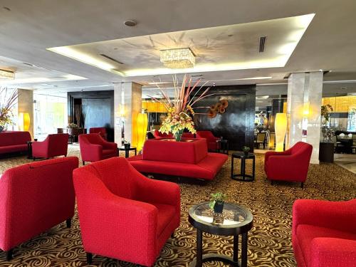 a lobby with red chairs and red chairs at Pearl View Hotel Prai, Penang in Perai