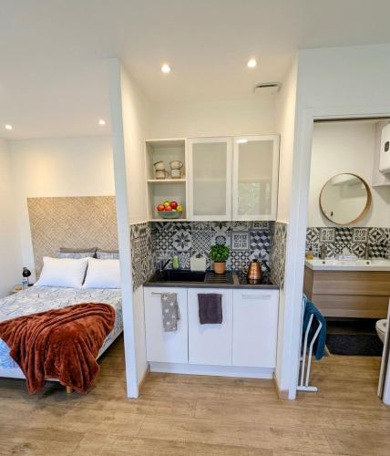 a small bedroom with a bed and a bathroom at LE CHARME D OGNES in Ognes