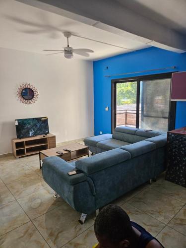 a living room with two couches and a tv at Hot Payton in Mamoudzou