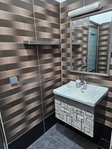 a bathroom with a sink and a mirror at Hot Payton in Mamoudzou