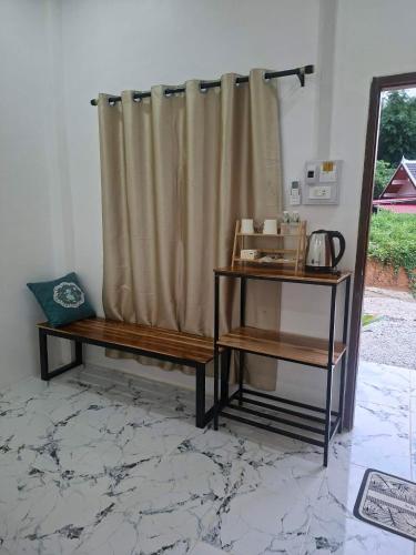 a room with two benches and a shower curtain at Sokmoungkhoun in Nongkhiaw