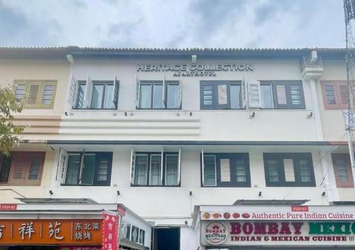 a white building with a sign on the side of it at Heritage Collection on Pagoda - Mobile App Check-In in Singapore