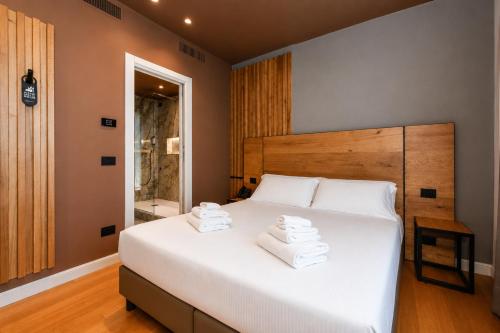 a bedroom with a large white bed with towels on it at Best Western Hotel Arya in Sirmione