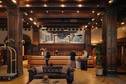 a group of people in a church with a bench at Chicago Athletic Association, part of Hyatt in Chicago