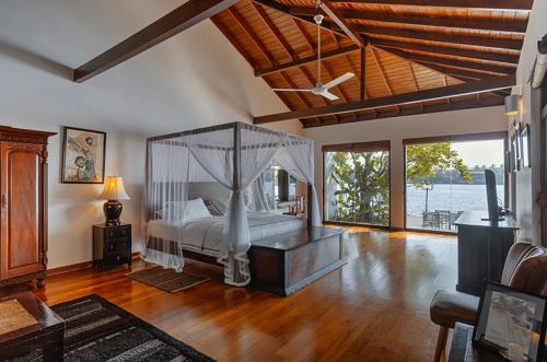 a bedroom with a bed with a canopy at Villa Republic River View Bentota in Aluthgama