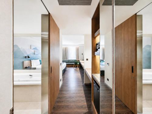 a corridor of a hotel room with sliding doors at Just Sleep Hualien ZhongZheng in Hualien City