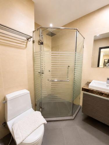 a bathroom with a shower and a toilet and a sink at Sea View Room - Infinity Pool near Terminal 21 in Pattaya