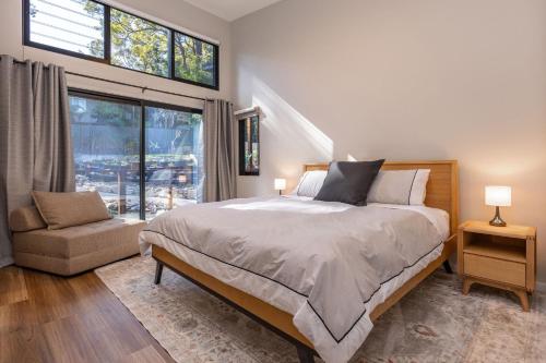 a bedroom with a large bed and a window at Valley Retreat in Smiths Lake