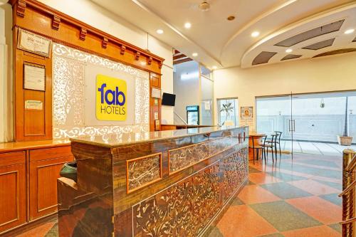 a hotel lobby with a bar and a restaurant at FabHotel Vaishanvi Palace in Hyderabad