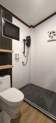 a bathroom with a toilet and a shower at Ladda Garden Home in Klong Muang Beach