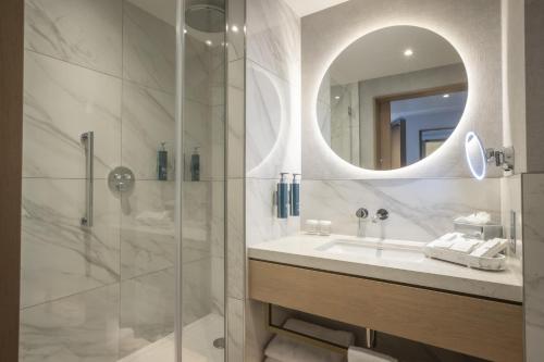 a bathroom with a sink and a mirror at Hilton Dublin in Dublin
