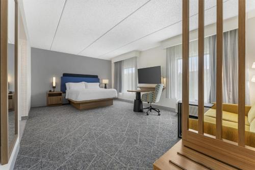 a hotel room with a bed and a desk at Hampton Inn & Suites Pittsburgh-Meadow Lands in Washington