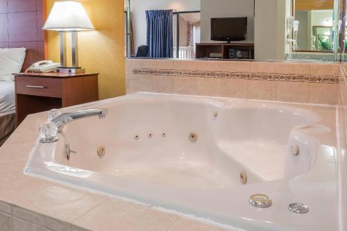 a large white bath tub in a hotel room at Quality Inn Sycamore - DeKalb in Sycamore