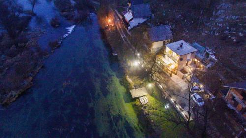 an aerial view of a house and a river at night at Moonriver Apartment in Veljun