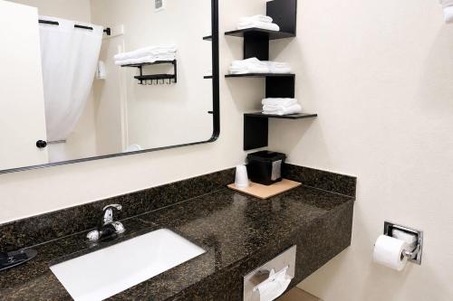 a bathroom with a sink and a mirror at Quality Inn Harrodsburg in Harrodsburg