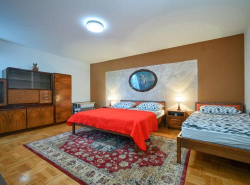 a bedroom with two beds and a flat screen tv at Requiem Rustical Heaven Villa with Outdoor Pool in Varaždin