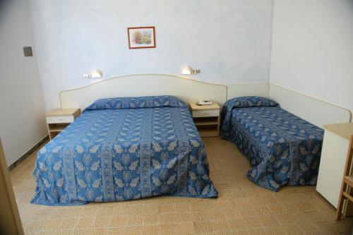Postel nebo postele na pokoji v ubytování Hotel Lorena