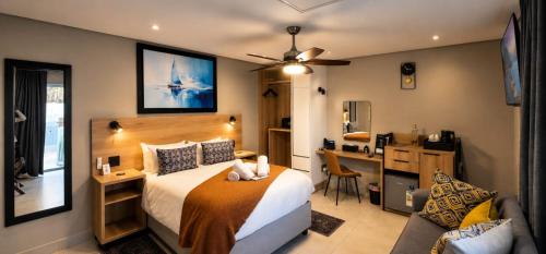 a hotel room with a bed and a desk and a desk at 78onJean in Centurion