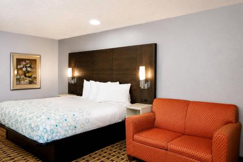 a hotel room with a bed and a chair at Masters Inn Augusta at Washington Road in Augusta