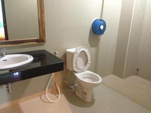 a bathroom with a toilet and a sink at Lankham Hotel in Pakse