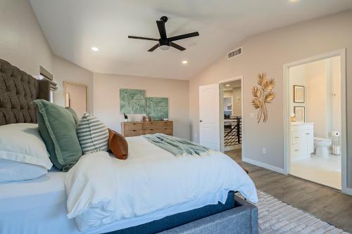 a bedroom with a bed and a ceiling fan at Dos Palmas - Gilbert Poolside Retreat in Gilbert