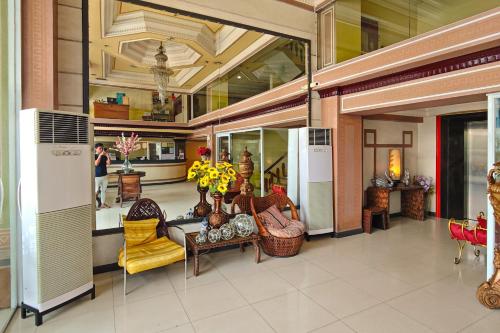a lobby with chairs and tables in a building at Hotel Uno in Davao City