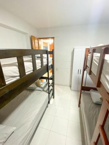 a room with two bunk beds in a room at Nutria Apt in Cerro Azul with access & ocean view in Cerro Azul
