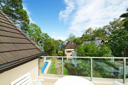 a balcony with a view of a house at Alderly Terrace in Noosa Heads