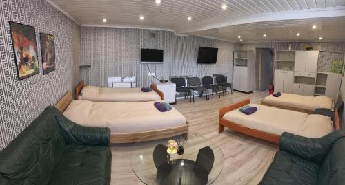 a room with two beds and a living room at Babilonas in Plungė