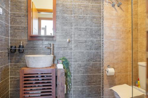 a bathroom with a sink and a mirror at Halkidiki Sunhouse in Paliouri
