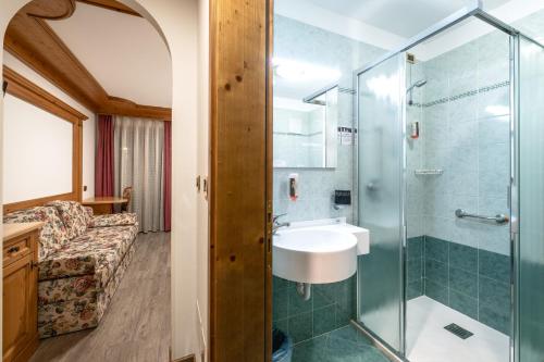 a bathroom with a shower and a sink at EL CIASEL in Canazei