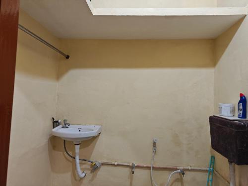 a bathroom with a sink in a room at Theprefabnest in Rishīkesh