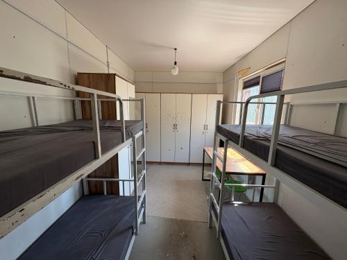 a room with two bunk beds and a hallway at Kushtar in Bishkek
