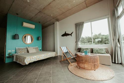 a bedroom with a bed and a mirror and a window at Balay Kalachuchi in Barili