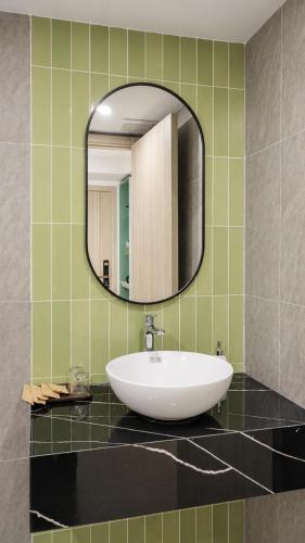 a bathroom with a sink and a mirror at Y Hotel Lý Hồng Thanh in Can Tho