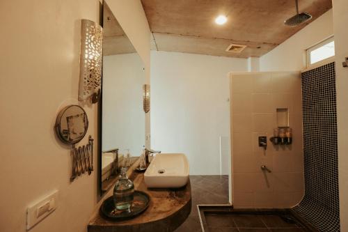 a bathroom with a sink and a toilet and a shower at Balay Kalachuchi in Barili