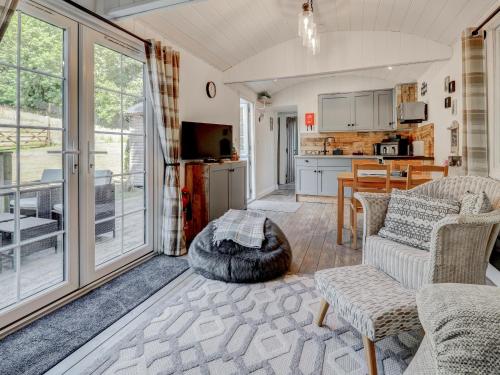 a living room with a couch and a table at Hoy Hideaway in Whitwell