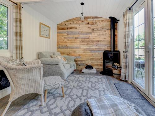 a living room with a couch and a fireplace at Hoy Hideaway in Whitwell