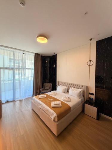 a bedroom with a large bed in a room at Waves Hotel NEW IN 2026 in Sarajevo